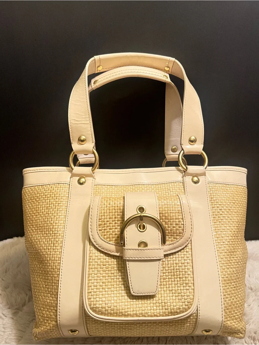 Coach white leather and straw tote.